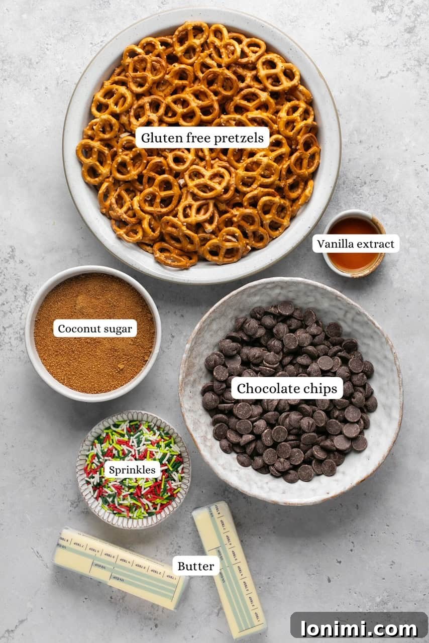 Addictive Gluten-Free Holiday Pretzel Bark 3 A vibrant flat lay showcasing all the essential ingredients for making pretzel Christmas crack, neatly arranged in nesting bowls on a rustic surface.