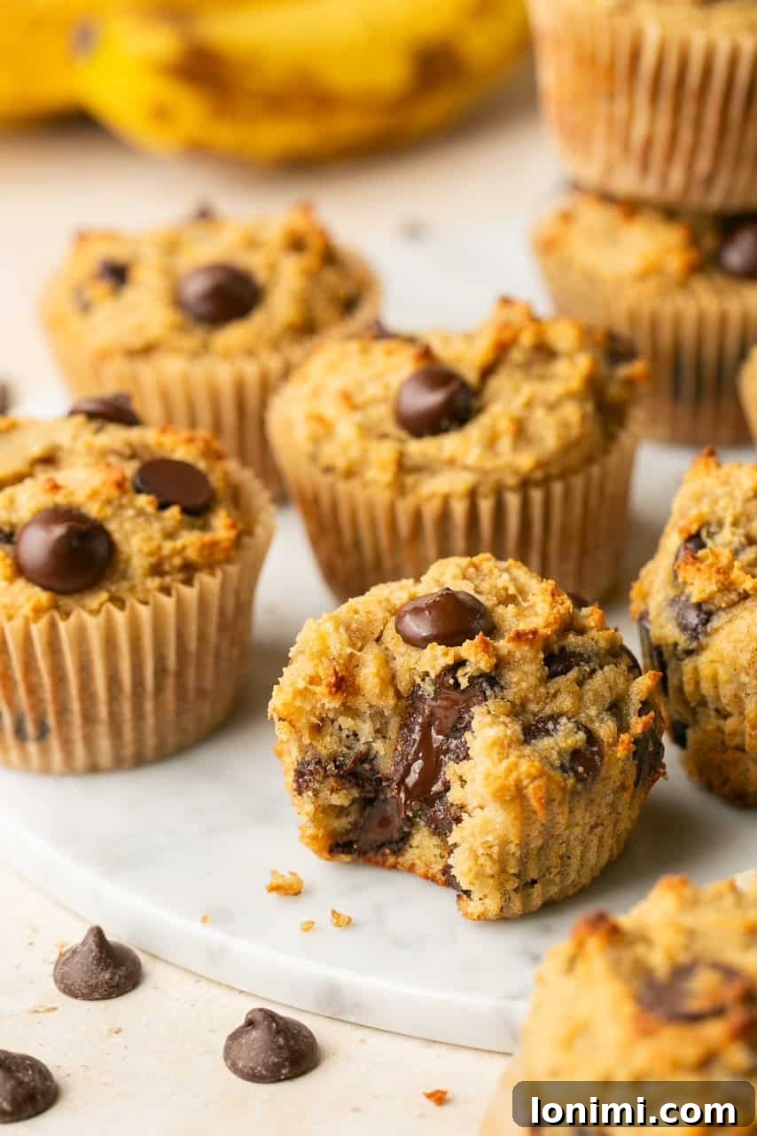 muffins on a marble circle with one with a bite taken out, enticingly displaying the soft interior