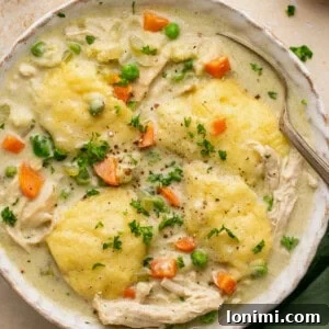 Effortless Gluten Free Chicken and Dumplings 10 gluten free chicken and dumplings in a bowl with a spoon topped with parsley