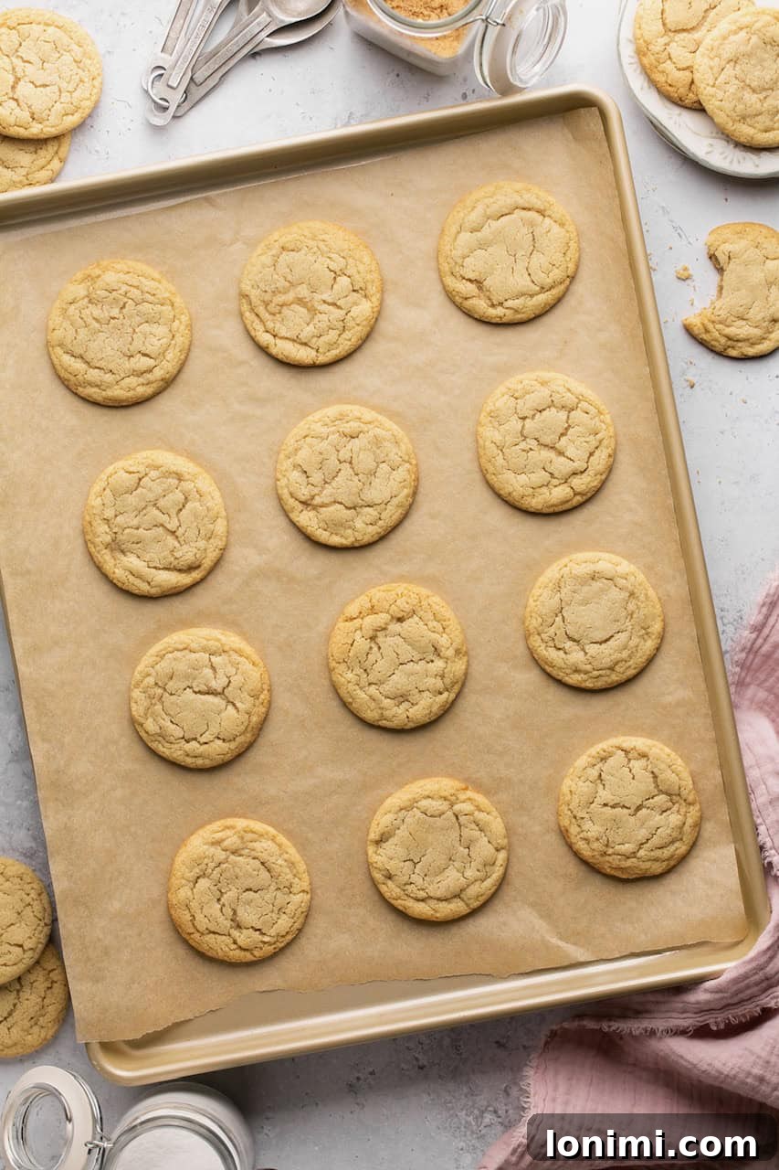 Freshly baked chipless cookies cooling on parchment paper on a wire rack.