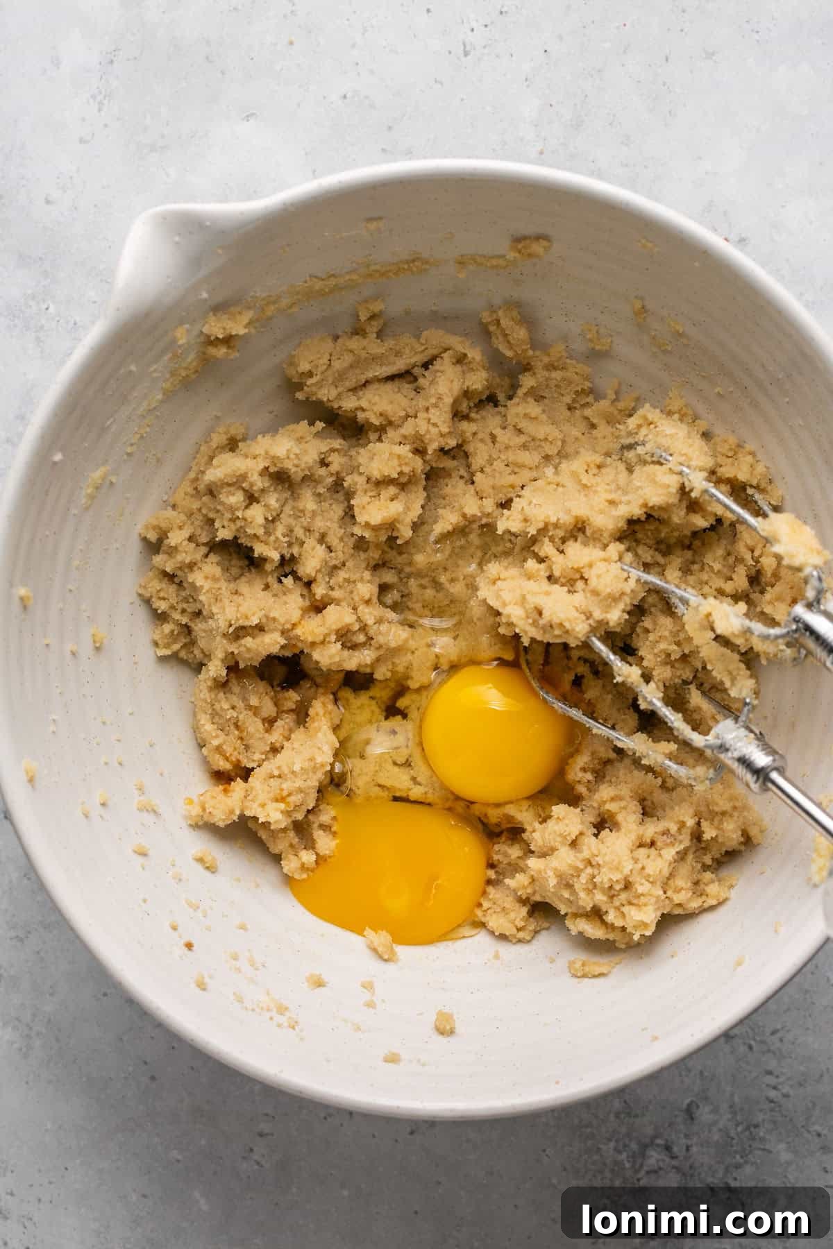 Butter and sugar mixture with one egg and an egg yolk added.