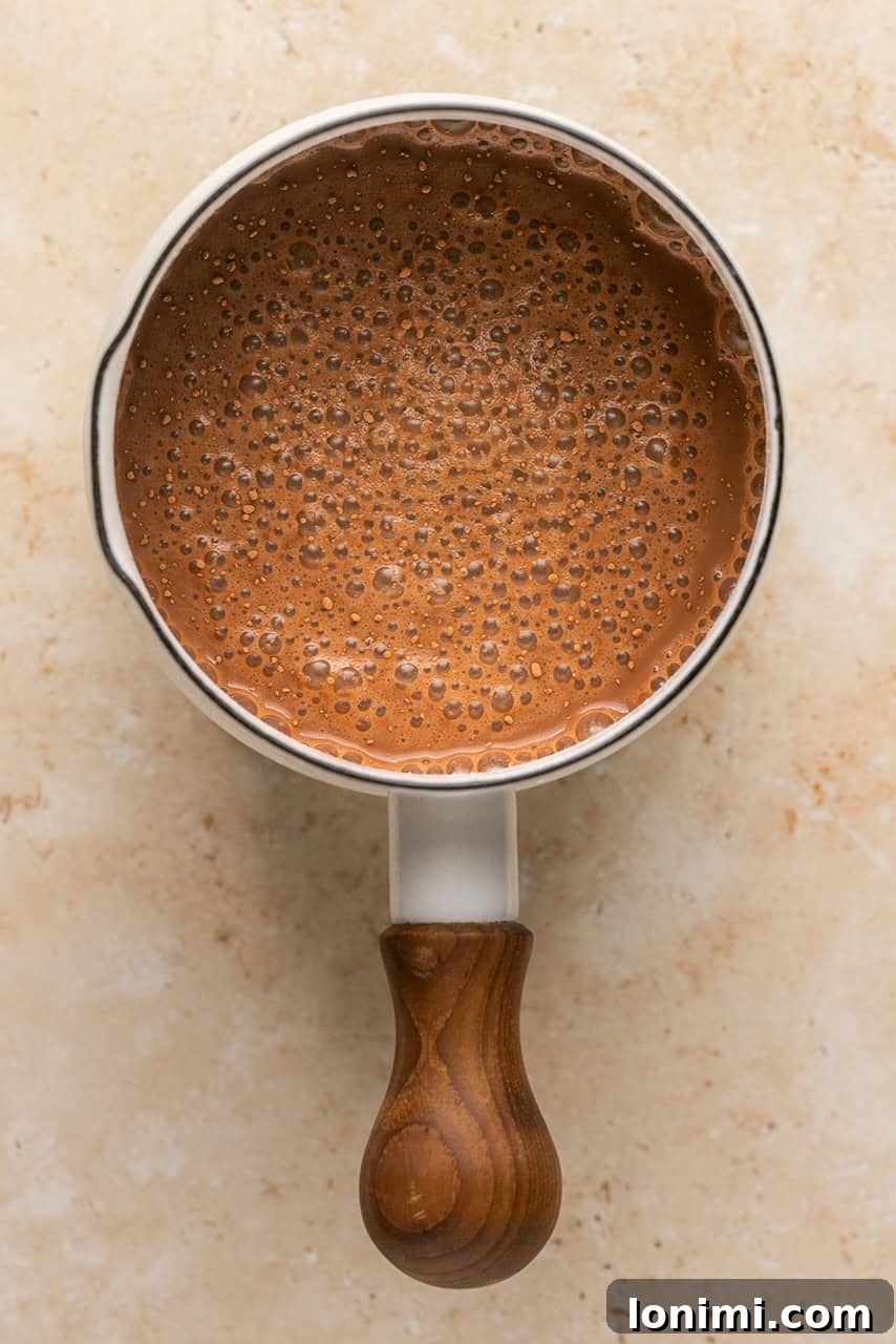Collagen Cocoa Elixir 5 bone broth hot chocolate in a sauce pan