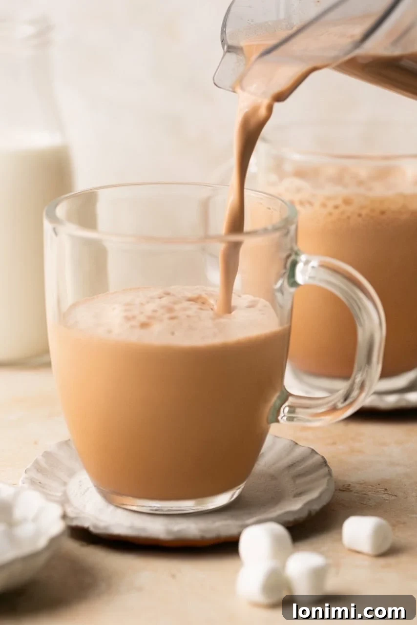 Collagen Cocoa Elixir 7 hot chocolate being poured into a mug