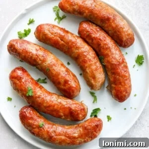air fried Italian sausage on a white plate topped with parsley