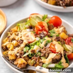 a bowl filled with big mac casserole with a wooden fork