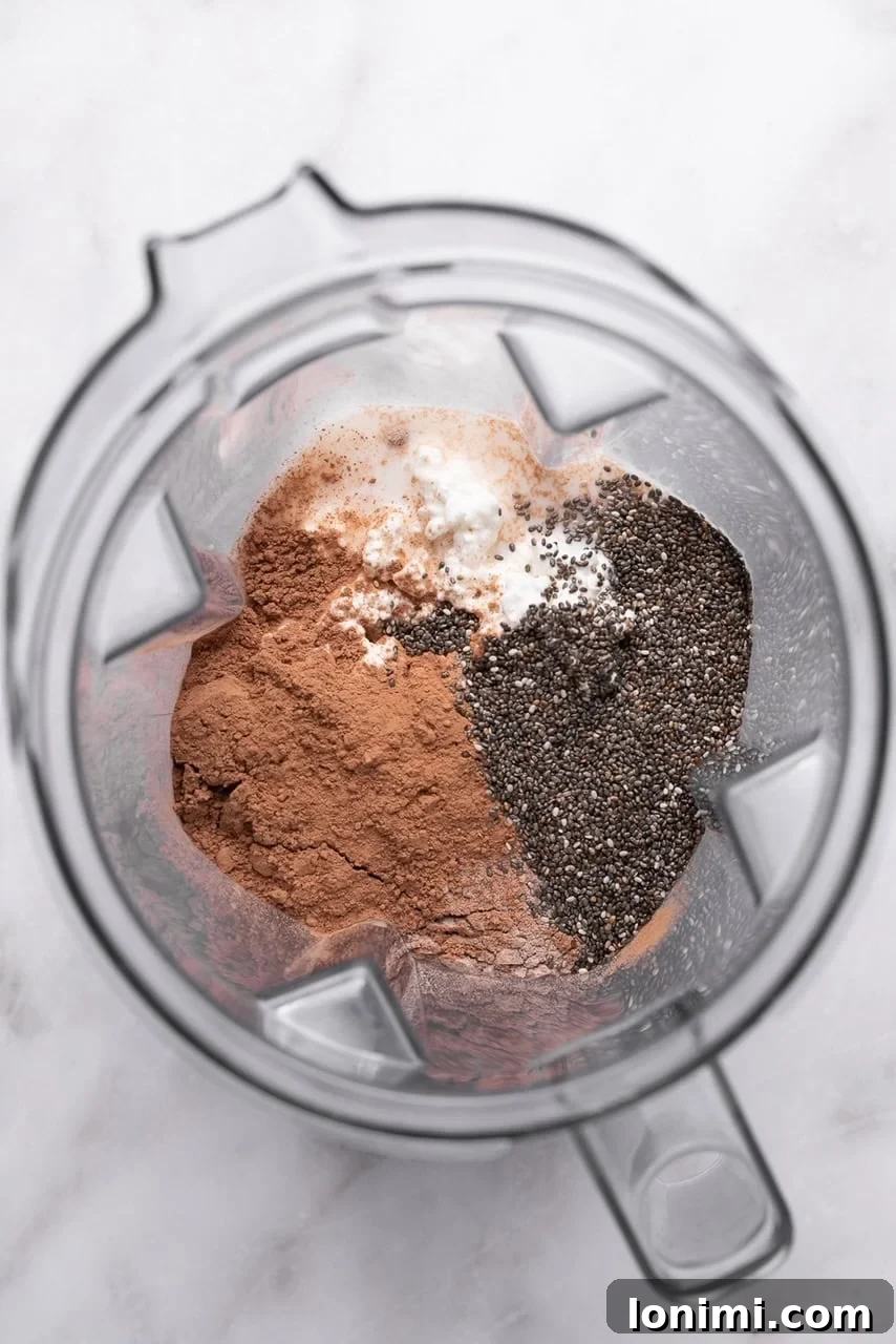 Protein chia pudding ingredients added to a high-speed blender before mixing.