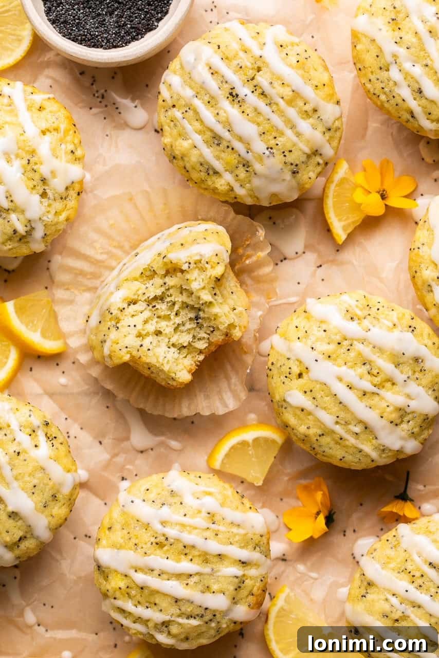 An overhead shot of freshly baked gluten-free lemon and poppyseed muffins drizzled with bright lemon glaze, ready to be enjoyed.