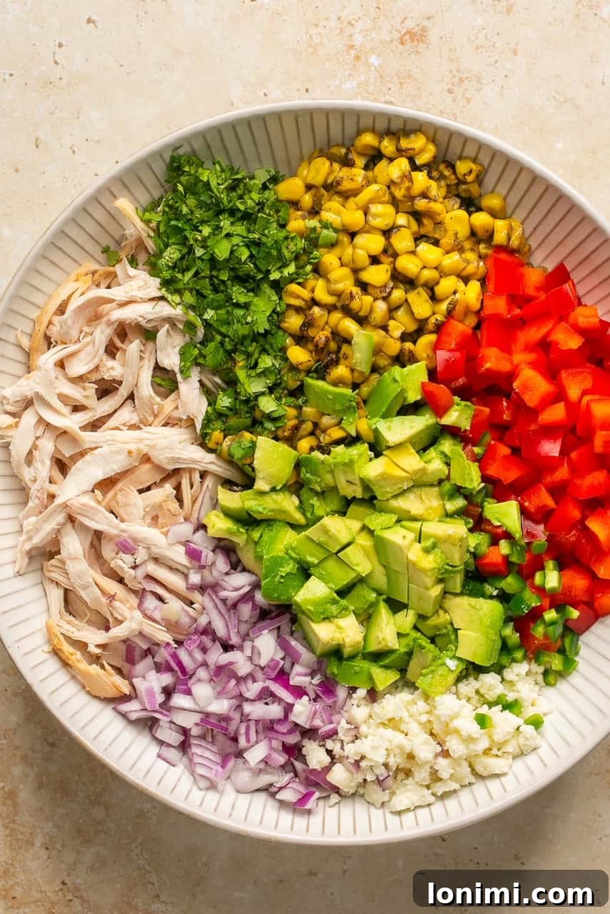 All the salad ingredients combined in a large mixing bowl, ready for the dressing
