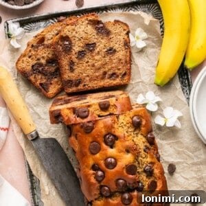 Protein banana bread with chocolate chips on a parchment lined baking sheet.