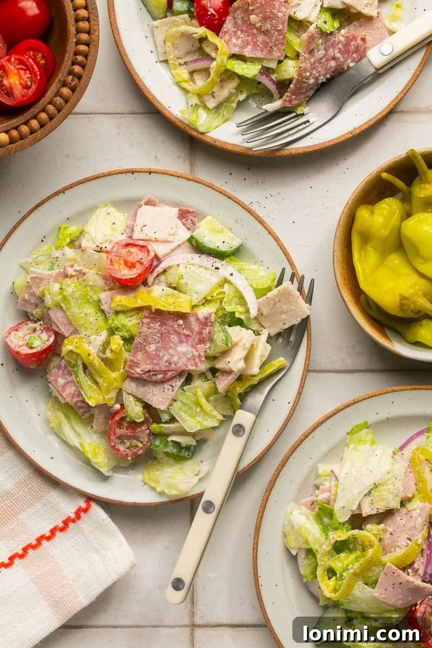 Individual servings of the Chopped Italian Grinder Salad presented on white plates, showcasing its appeal as a complete meal.