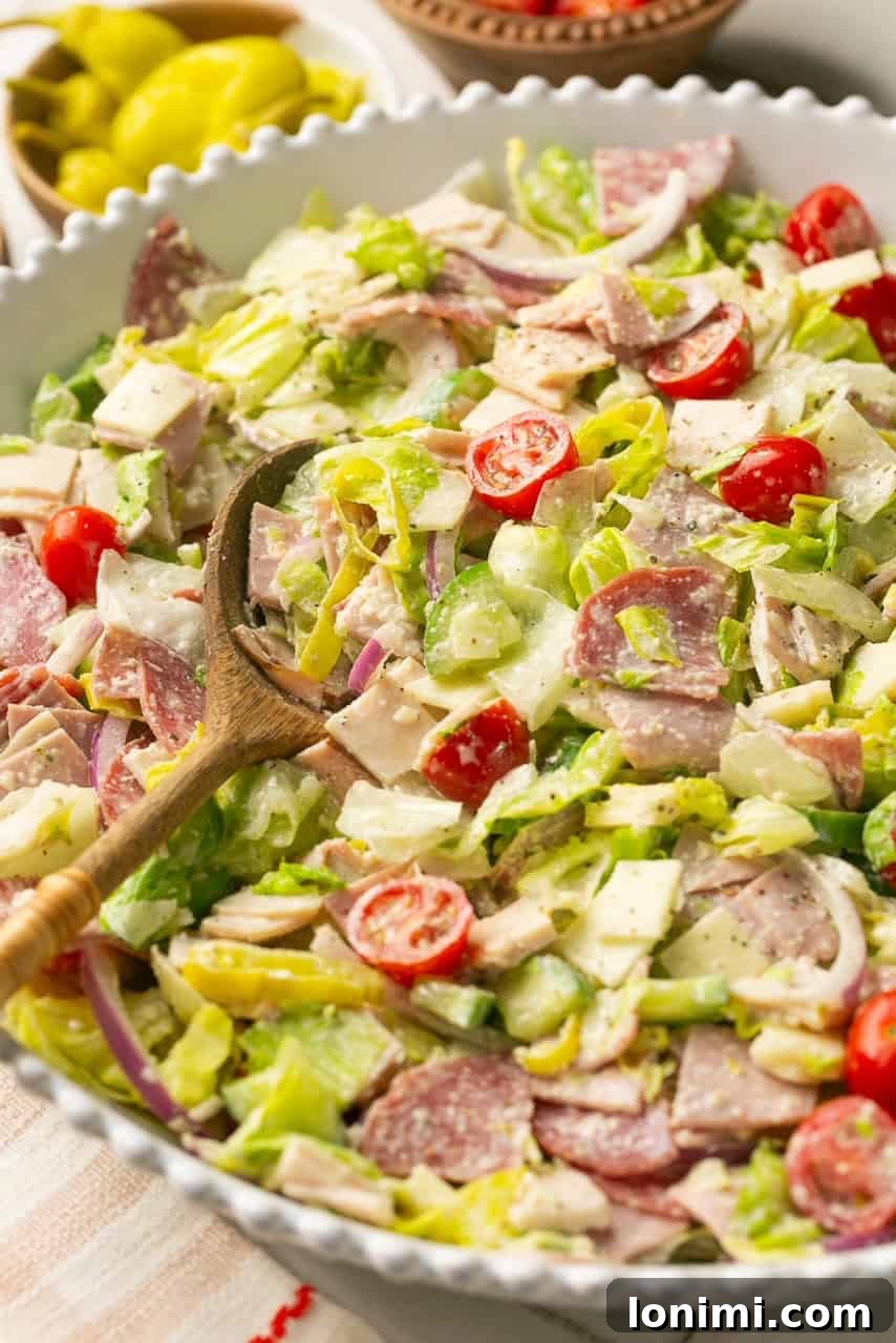 An inviting close-up photo of the Chopped Italian Grinder Salad in a white serving bowl, highlighting its textures and colors.