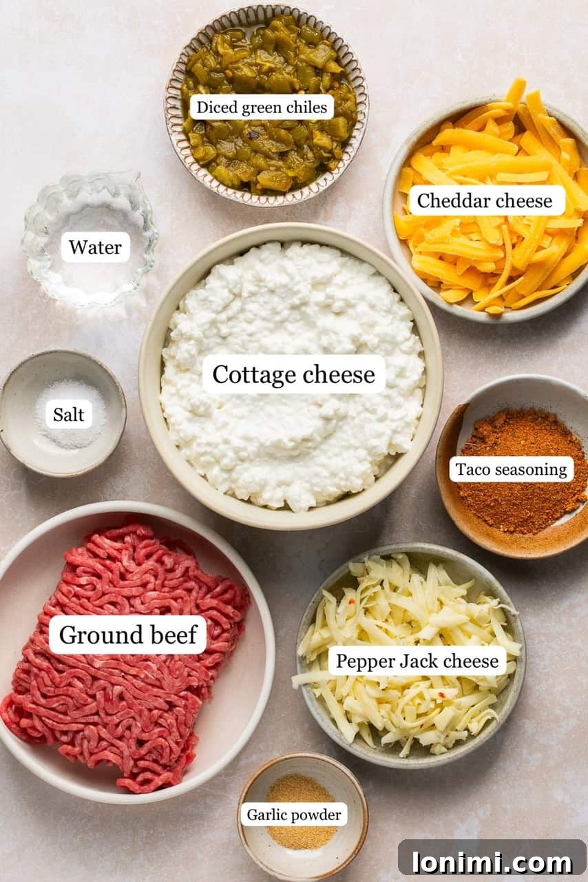 The Viral Protein-Packed Cottage Cheese Queso 3 Individual bowls displaying the fresh ingredients required for preparing high-protein cottage cheese queso, including lean ground beef, cottage cheese, assorted shredded cheeses, taco seasoning, and diced green chiles.