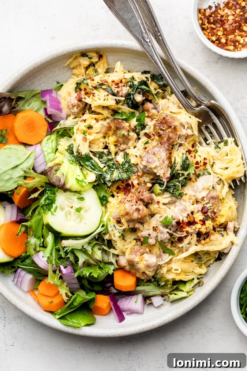 A single serving bowl of Tuscan spaghetti squash casserole, perfectly paired with a fresh, crisp green salad on the side, highlighting a complete and healthy meal.