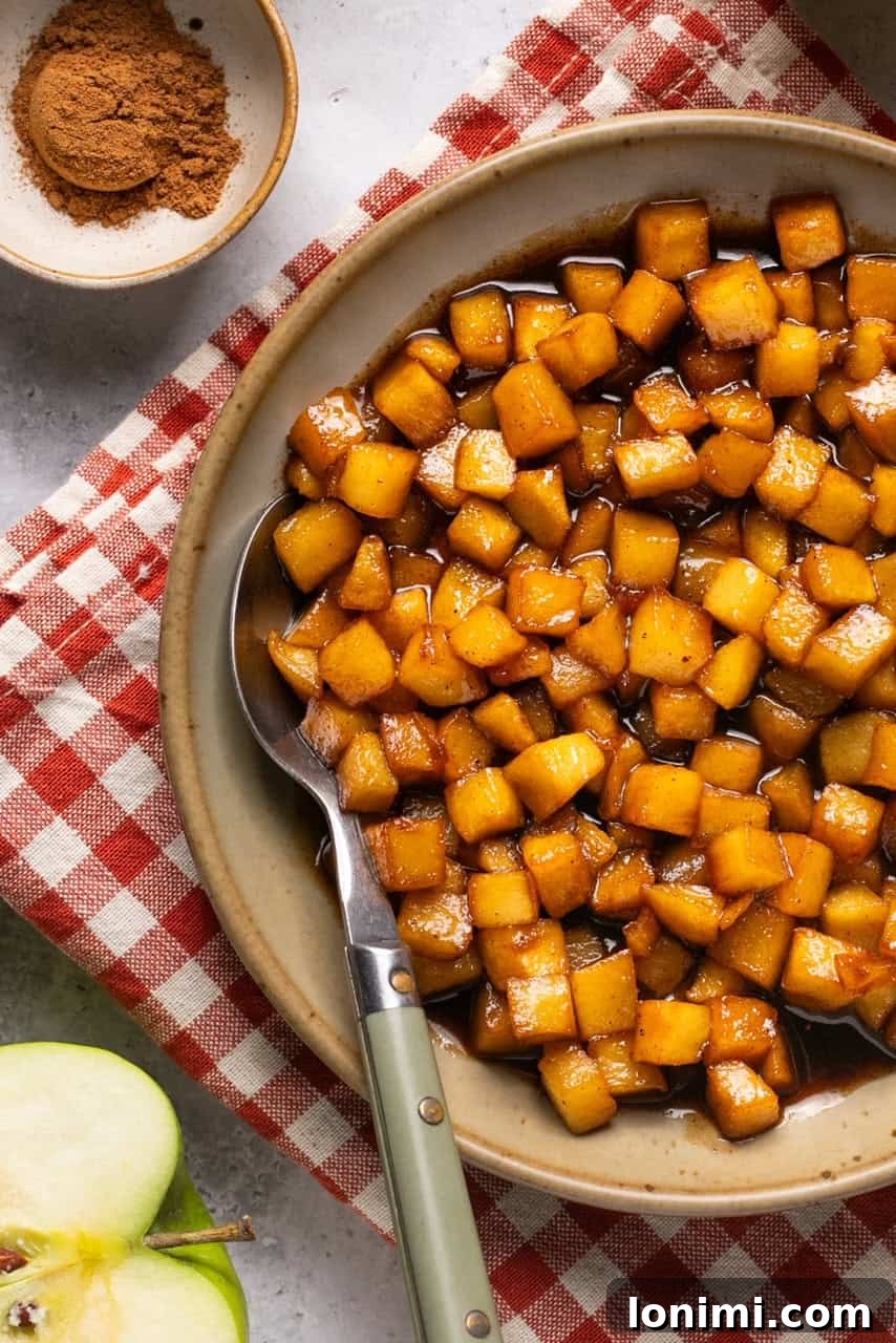A close-up shot of a bowl filled with perfectly caramelized apples, showing their golden color and tender texture, ready to be served.