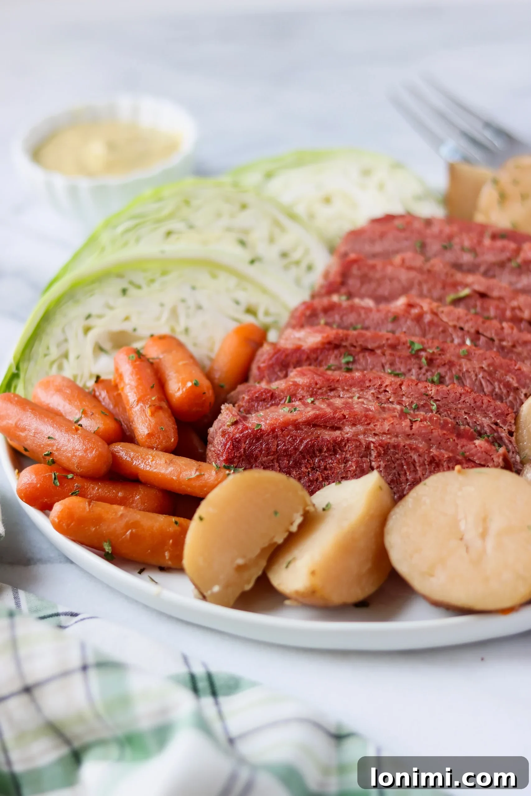 Plated Slow Cooker Corned Beef and Cabbage with Potatoes, Carrots, and Mustard