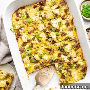 Sausage Hash brown casserole with green onions sliced in a white Staub casserole dish