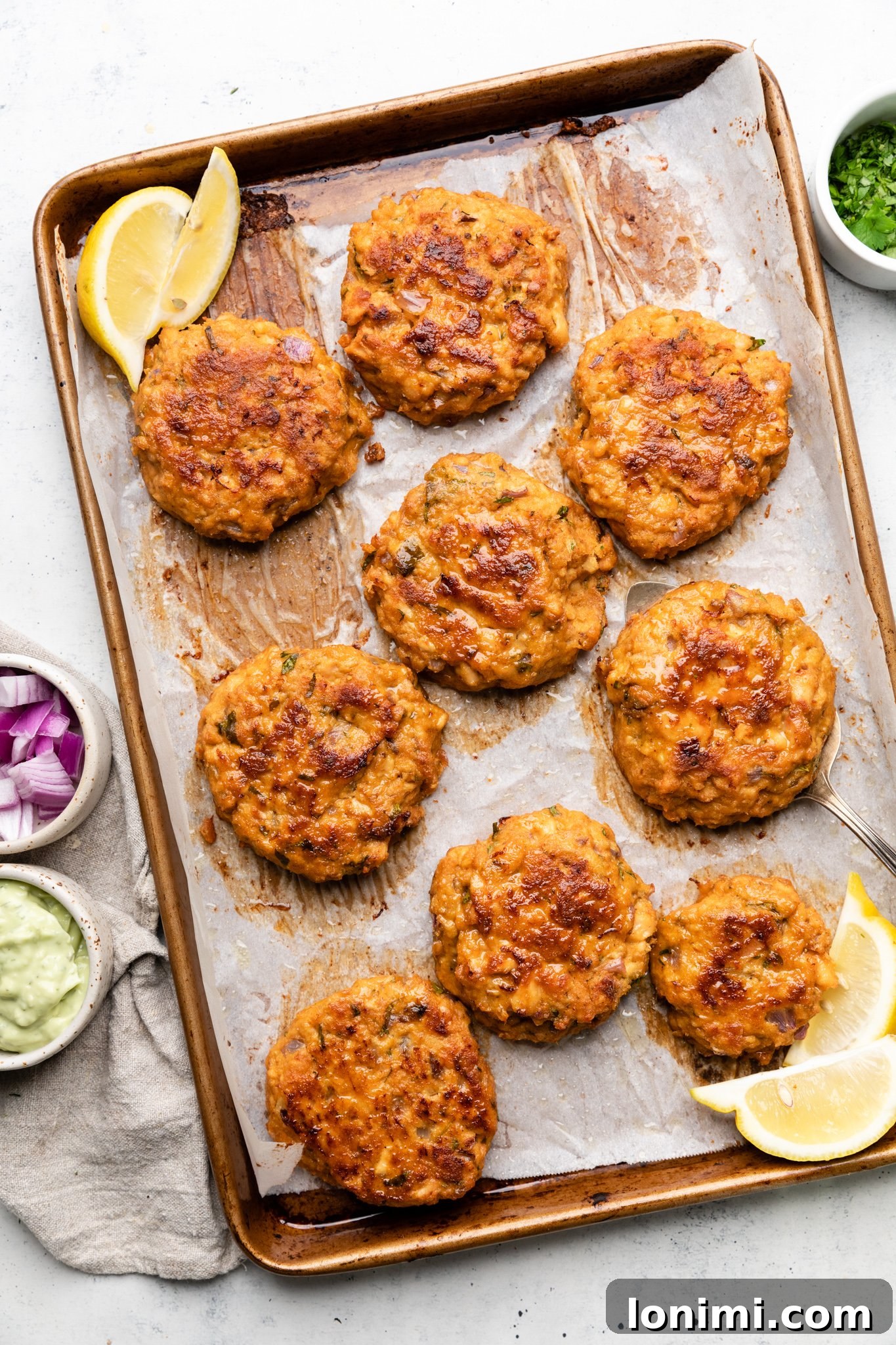 Spicy Southwest Keto Salmon Cakes with Creamy Avocado Aioli 5 Baked salmon patties on a baking sheet