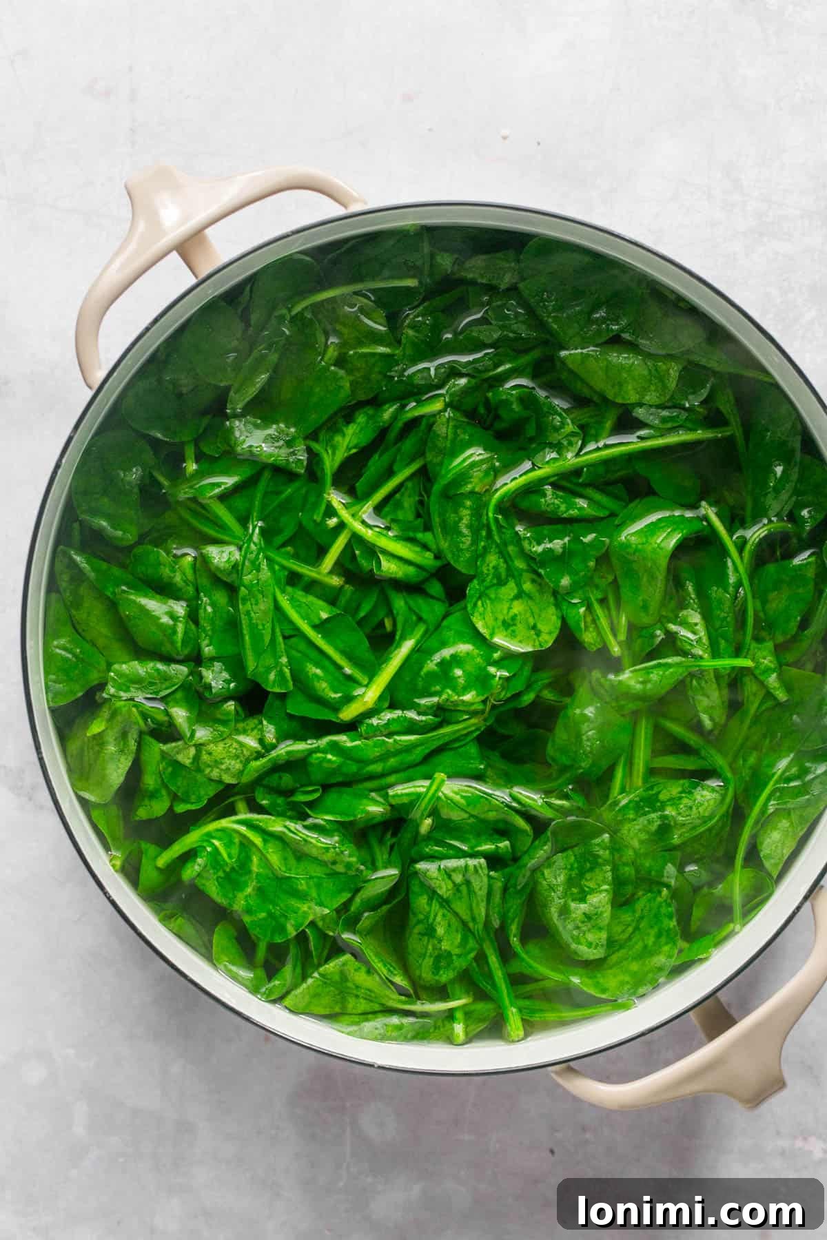 Decadent Mayo-Free Spinach Artichoke Dip 4 Raw spinach in a pot of boiling water
