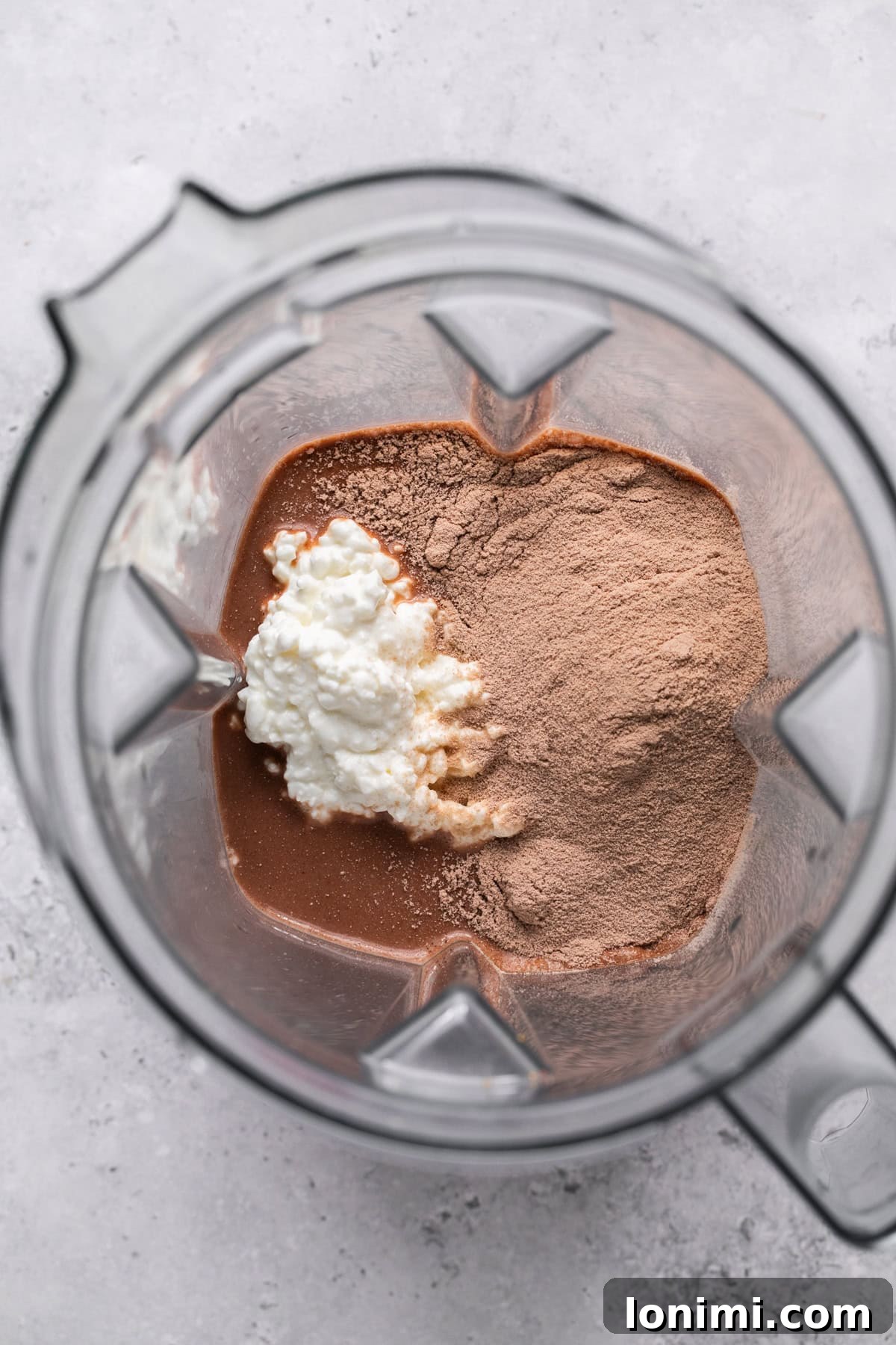 Easy Ninja Creami Protein Ice Cream with 4 Ingredients and 24g Protein 4 Recipe ingredients in a blender