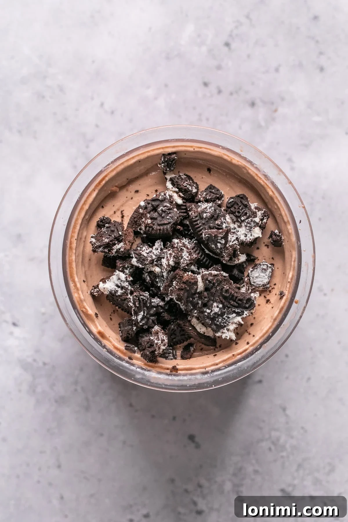 Easy Ninja Creami Protein Ice Cream with 4 Ingredients and 24g Protein 9 Oreo cookies crushed on top of the Ninja Creami frozen dessert