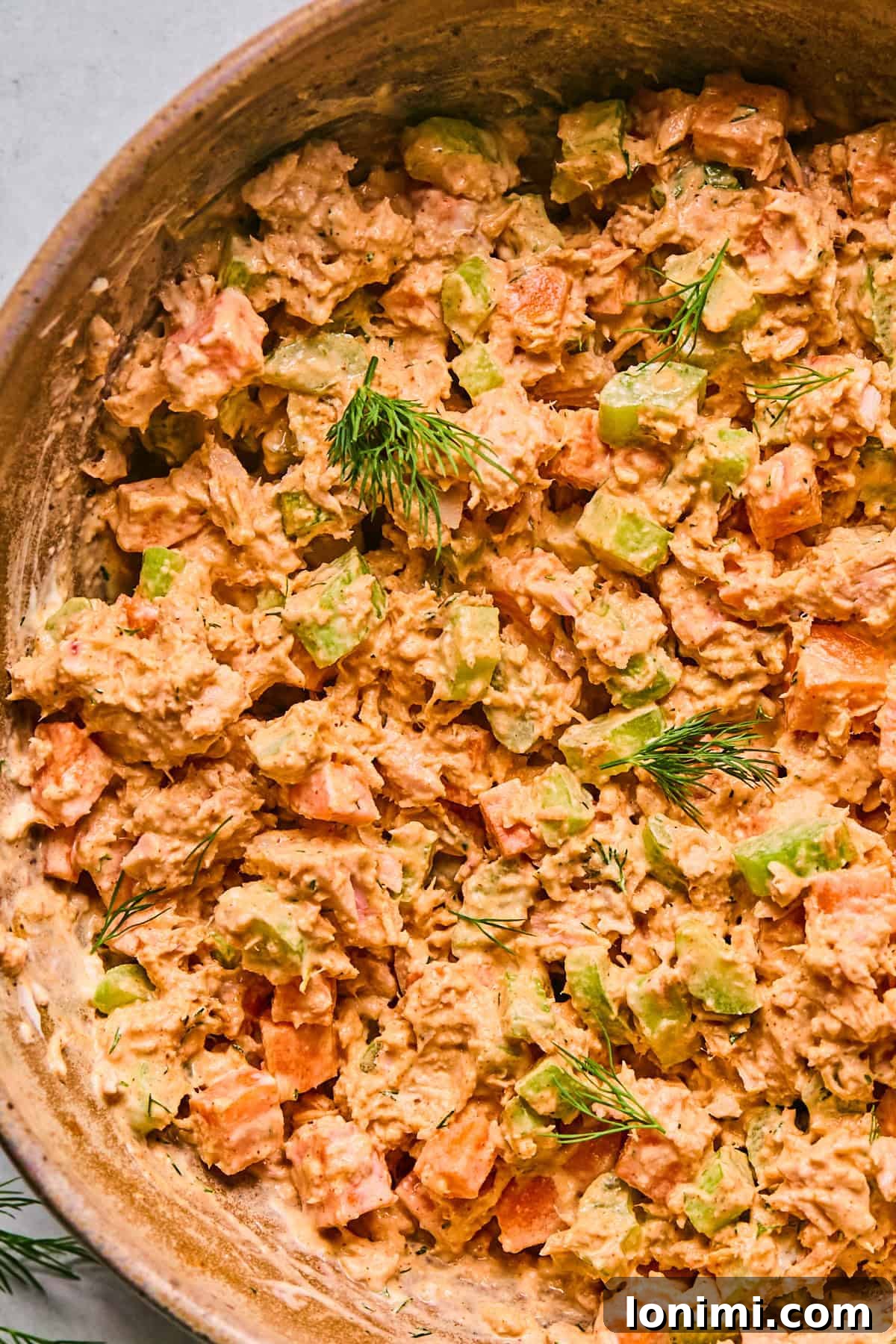 a close up to show the texture and creaminess of the salad topped with fresh dill