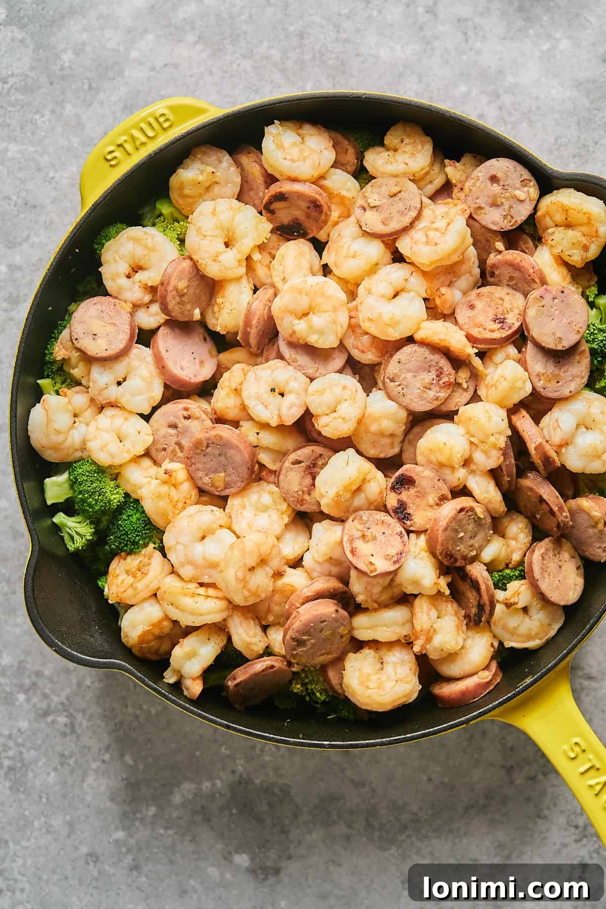 Gluten Free Hot Honey Glazed Shrimp and Sausage Stir Fry 10 Cooked shrimp and sausage returned to the skillet, resting on a bed of steamed broccoli florets, ready for the sauce.