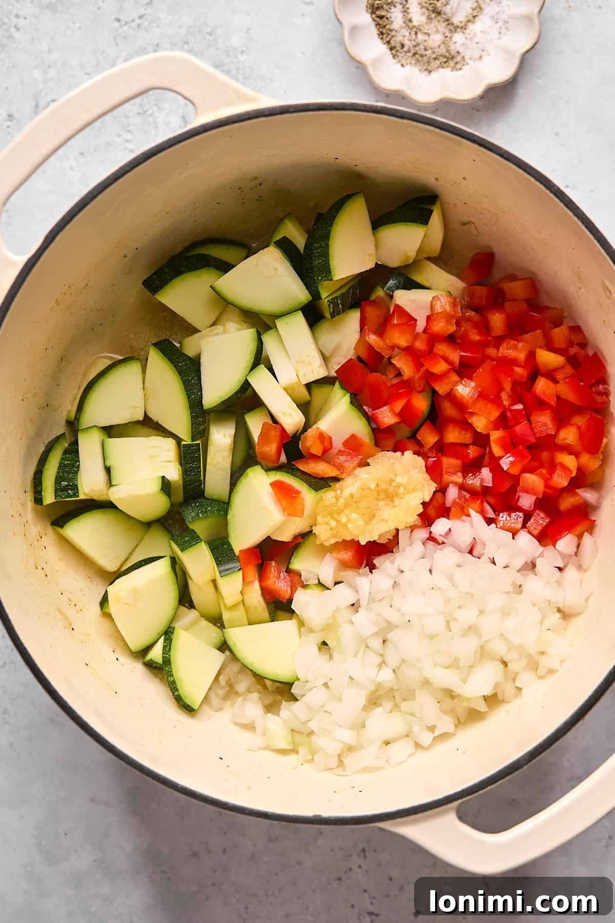 zucchini, bell pepper, and onion in a pot