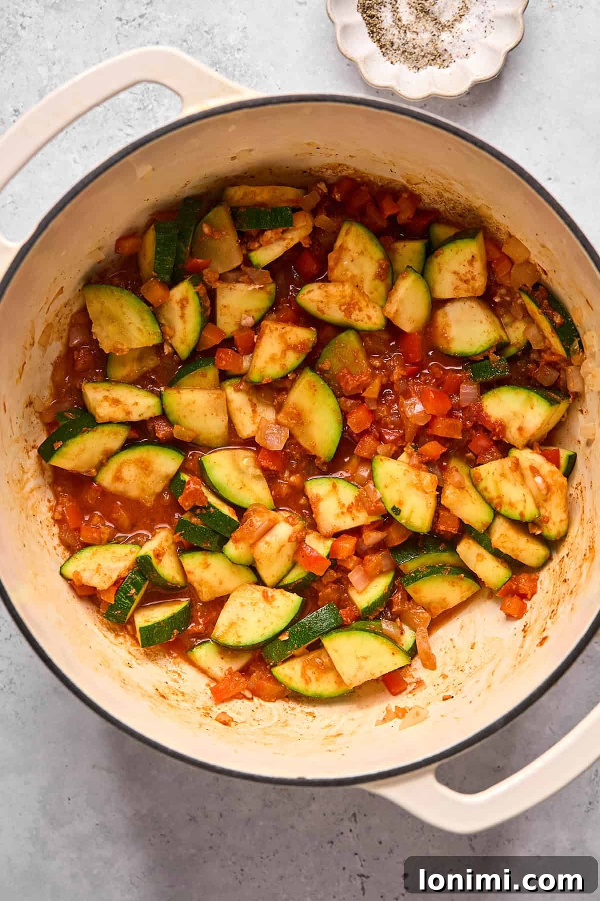 veggies with curry paste sauteed in a pot