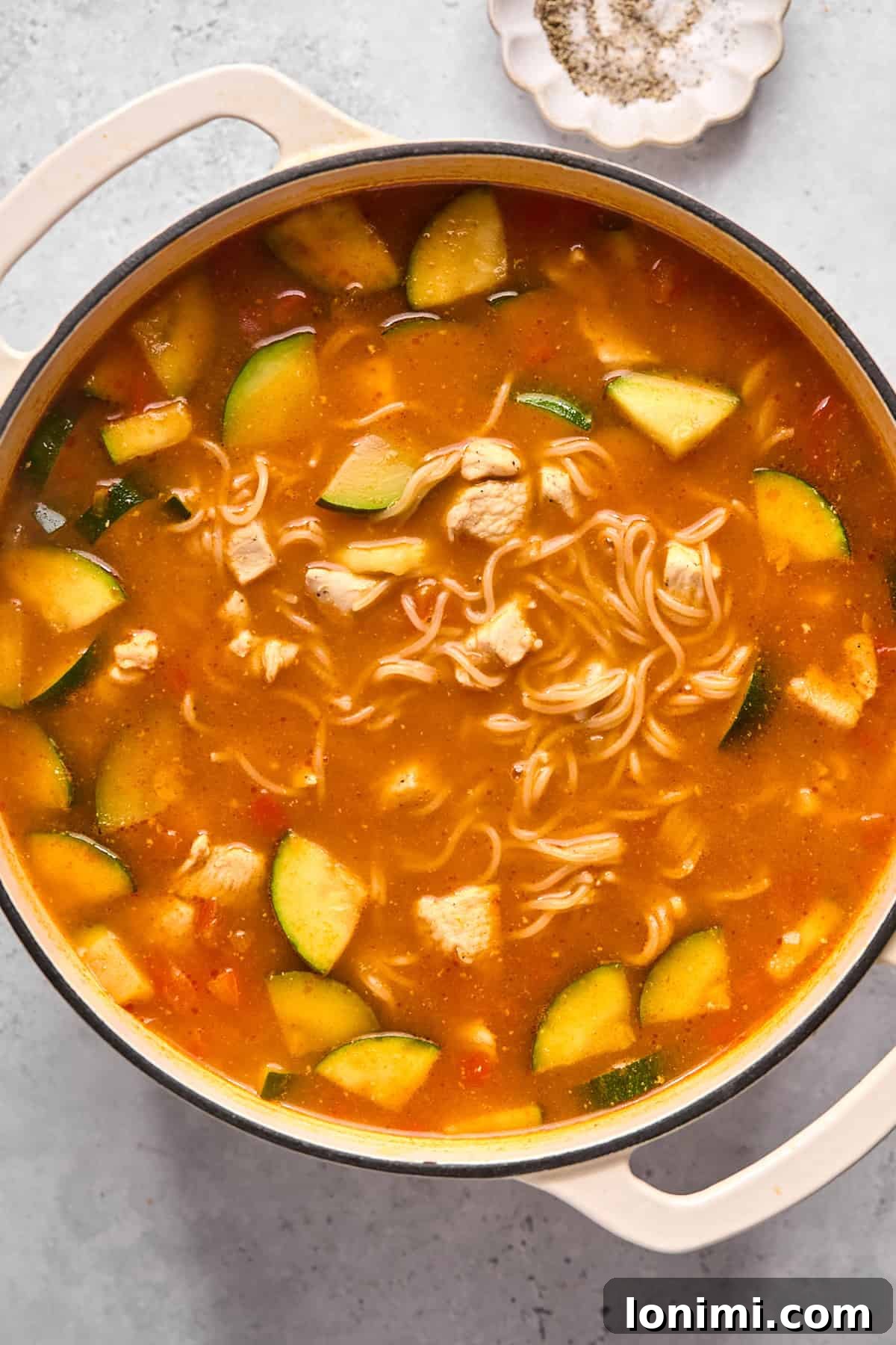 thai noodle soup with zucchini in a pot
