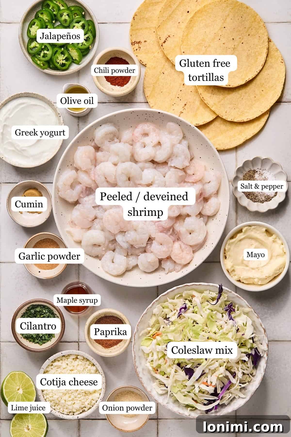 Various recipe ingredients arranged in small, labeled bowls, showcasing fresh produce and spices ready for preparation.