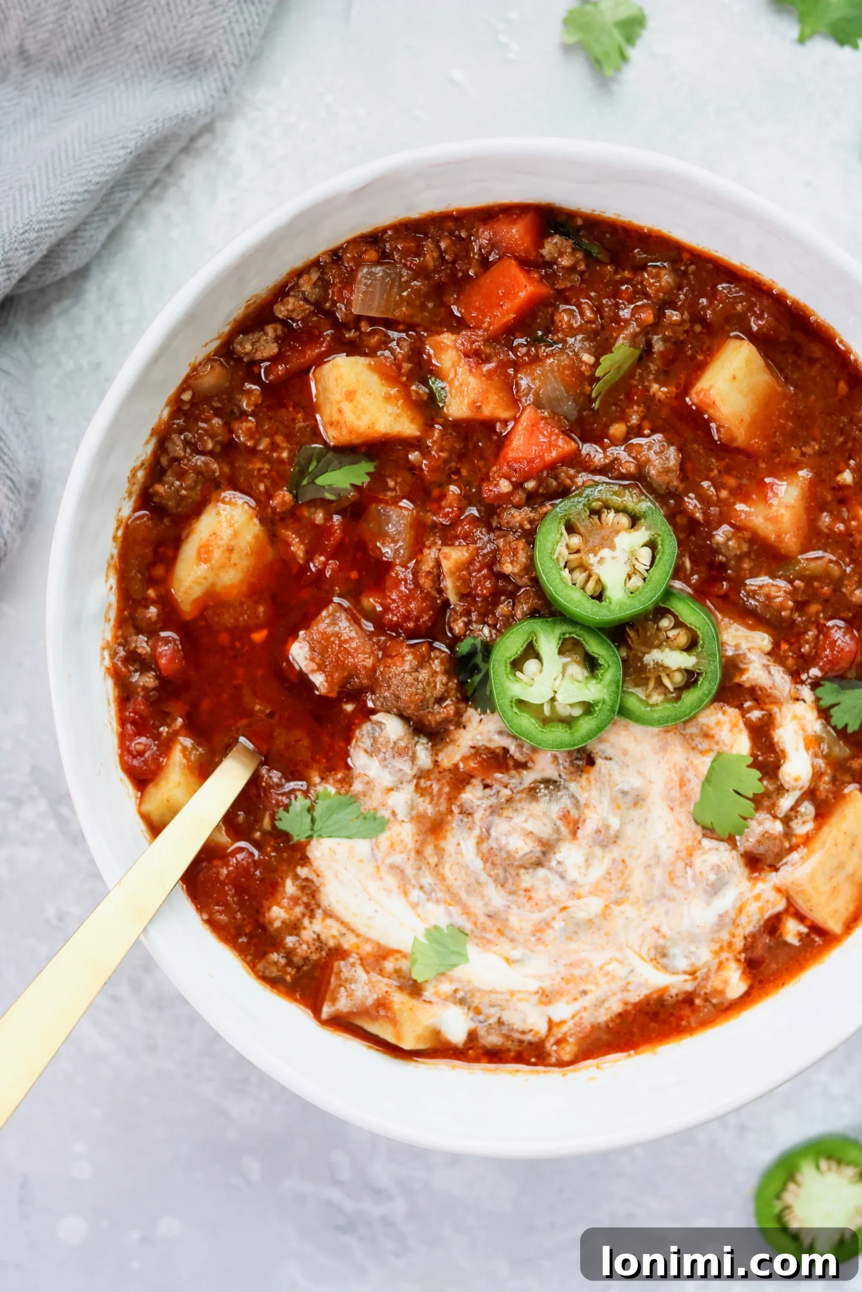 Hearty Slow Cooker Sweet Potato Chili in a bowl, garnished with fresh cilantro.