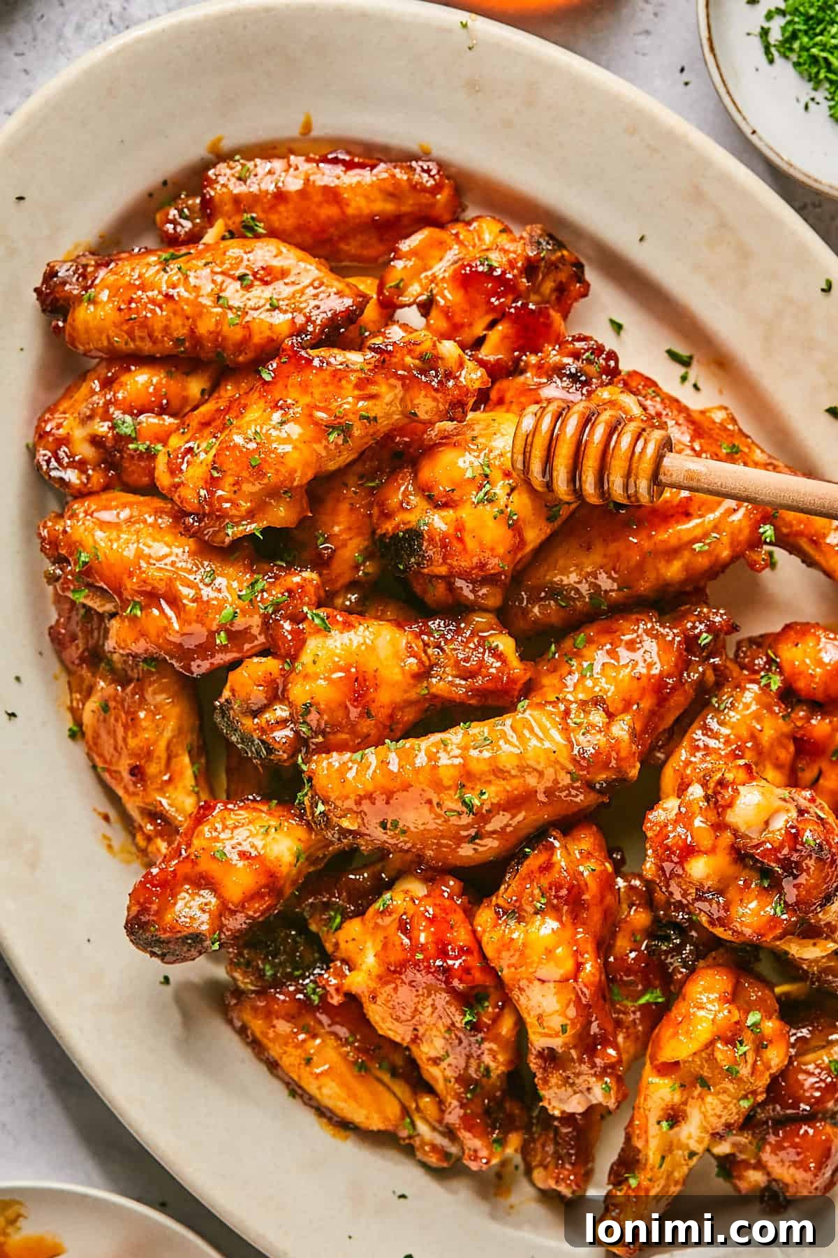 chicken wings with honey being drizzled on top