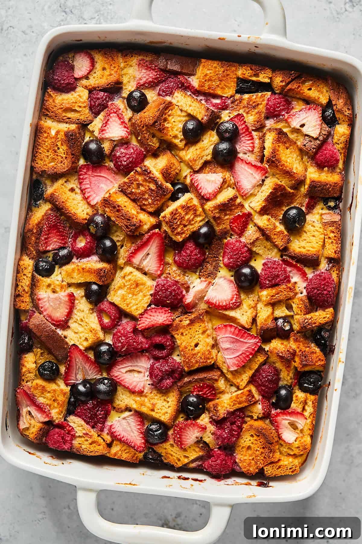Protein french toast casserole in a baking dish with berries