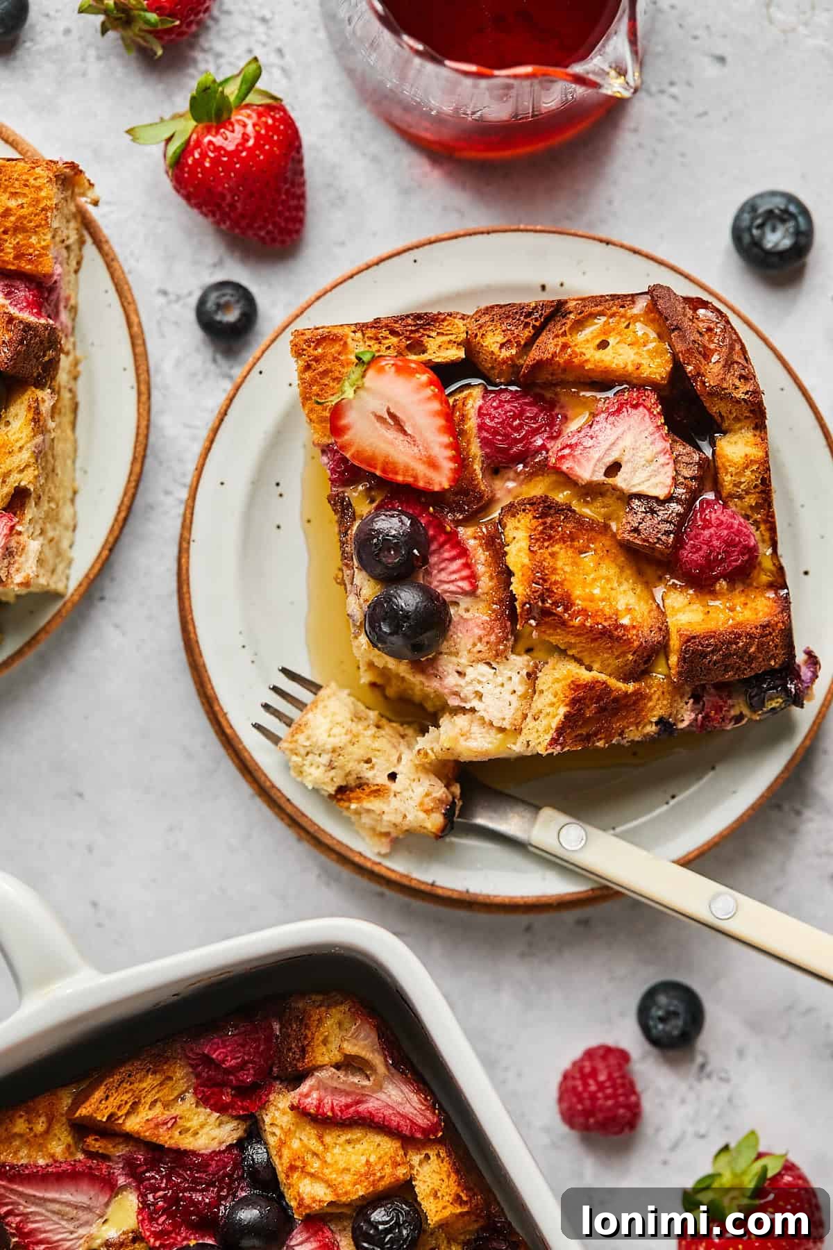 one square of french toast casserole on a plate with a fork. 
