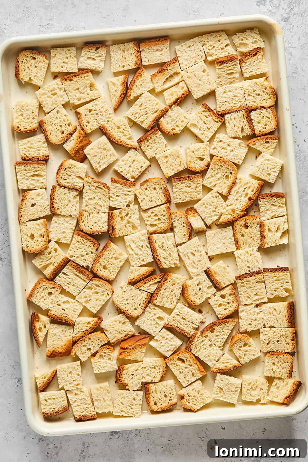 cubed bread on a baking sheet