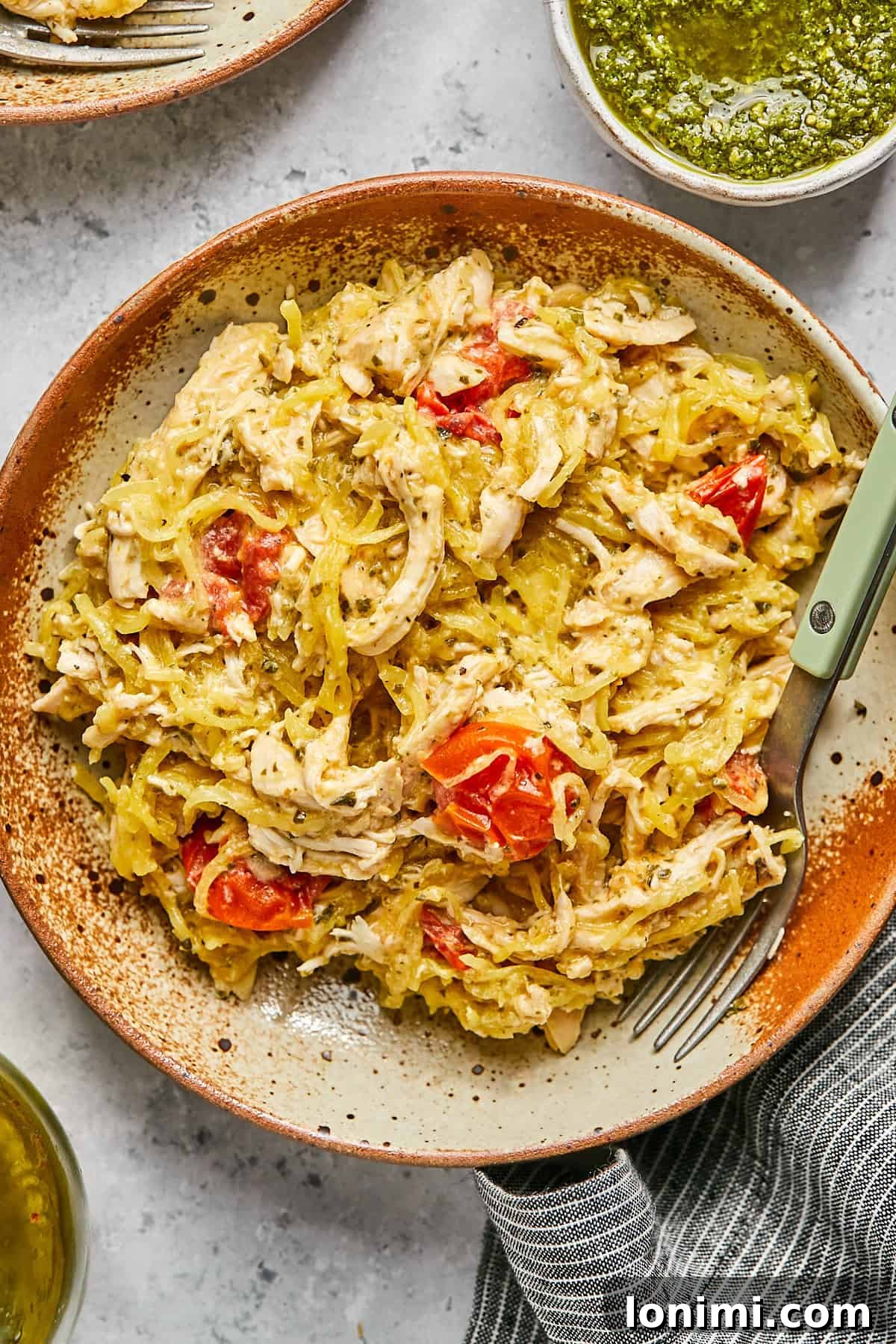 A comforting bowl of creamy Boursin chicken, tender spaghetti squash, and vibrant roasted tomatoes, ready to be enjoyed.