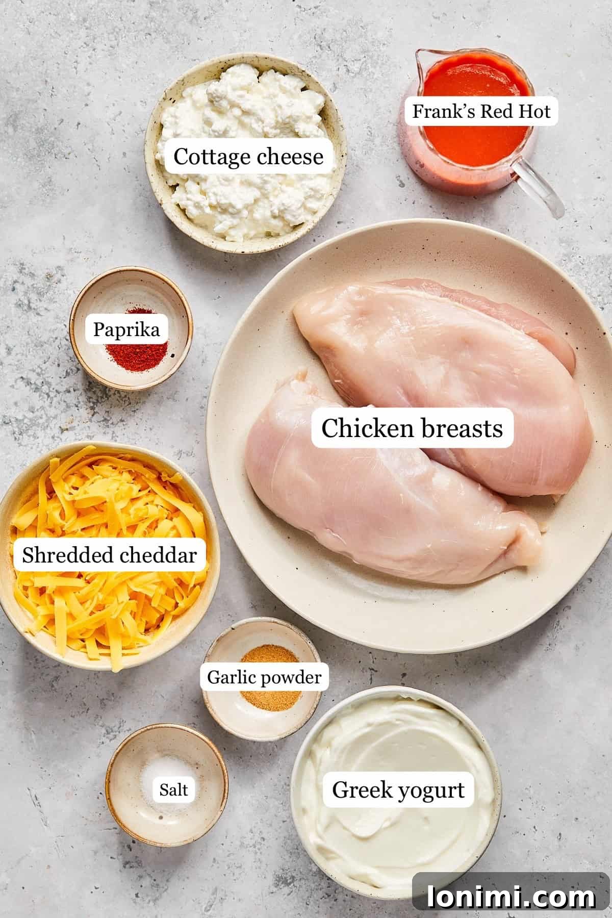 Various recipe ingredients laid out in small bowls and clearly labeled for easy identification.