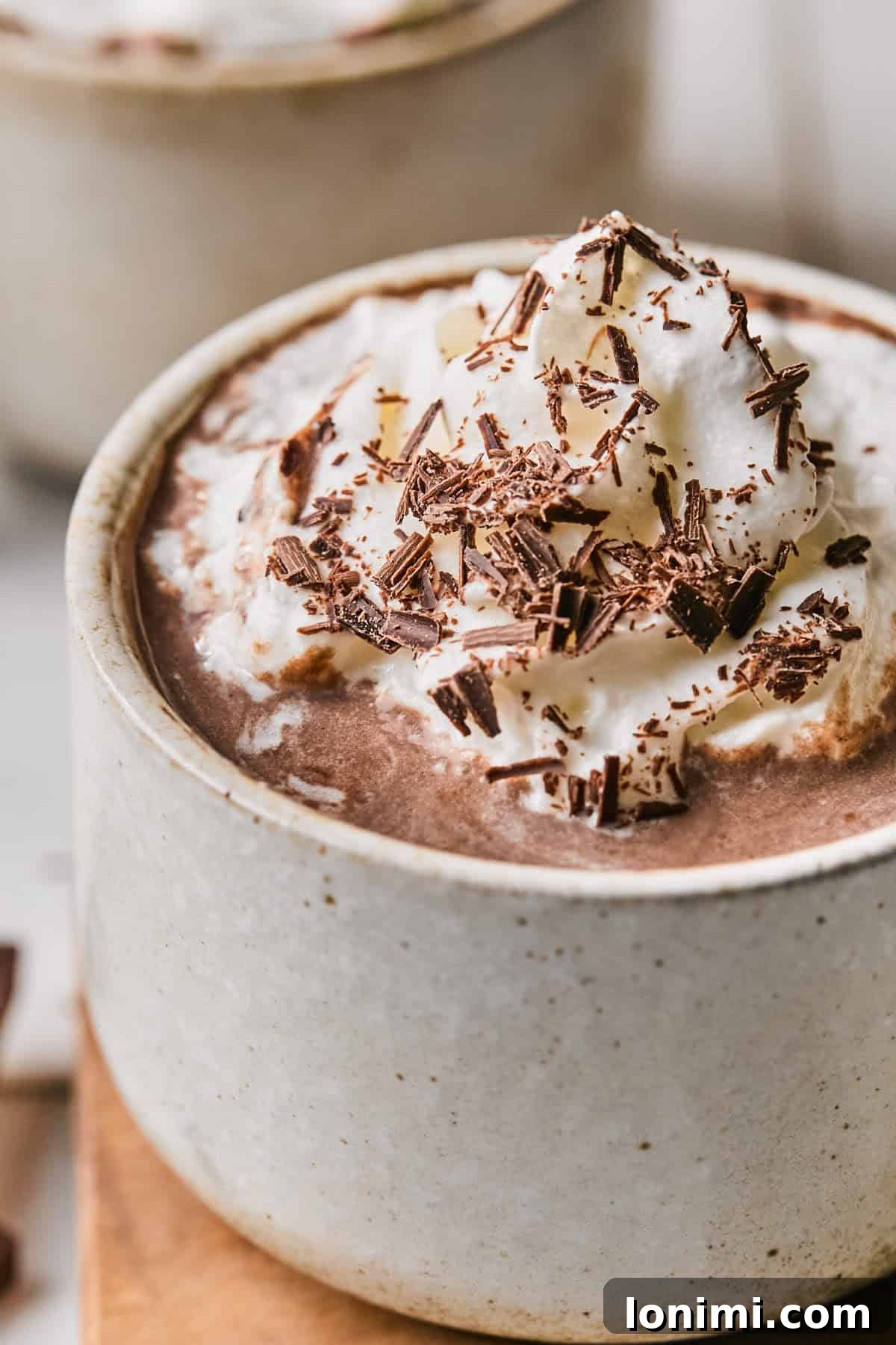 A close-up view of the rich, dark protein hot chocolate in a rustic mug, emphasizing its inviting warmth and smooth texture.