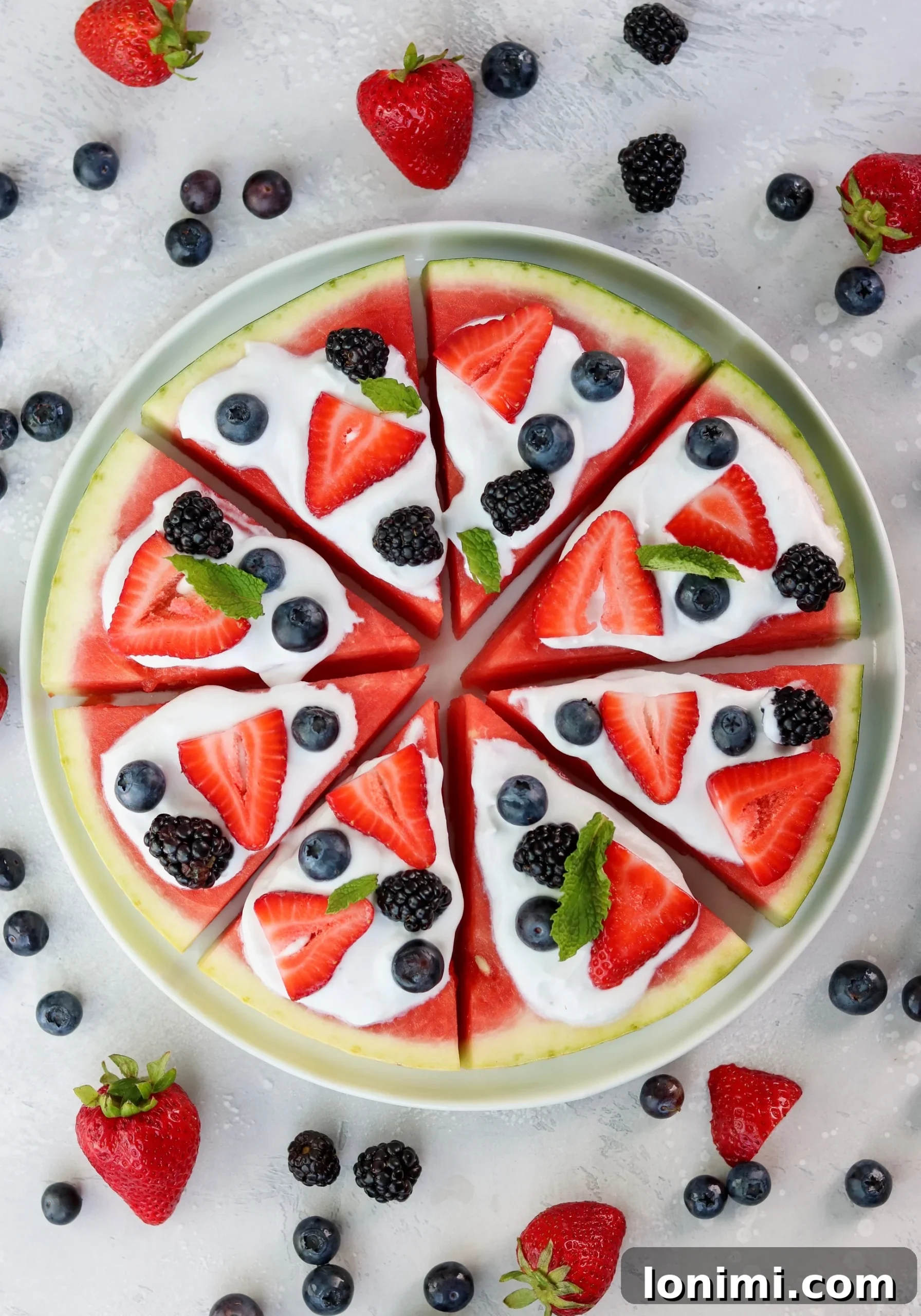 Delicious watermelon pizza topped with creamy homemade coconut whipped cream and fresh mixed berries, perfect for a summer gathering