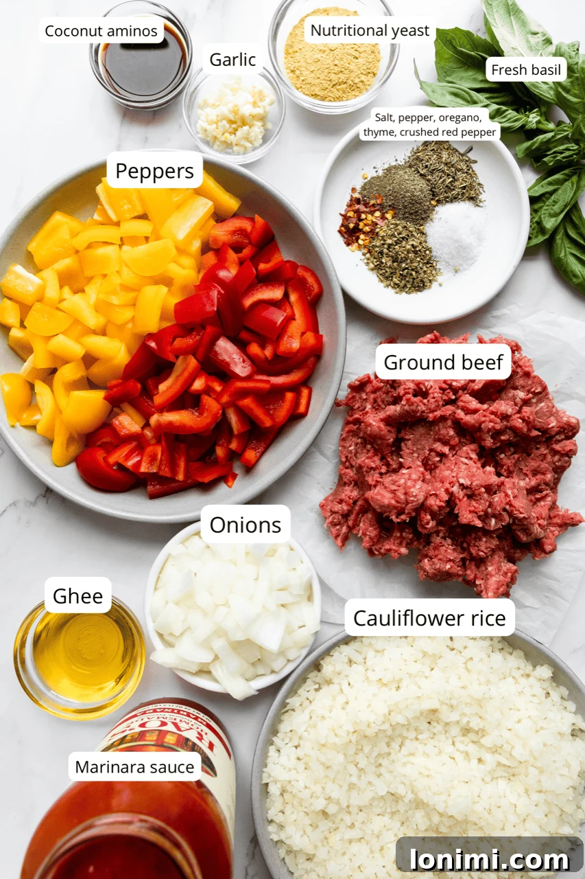 A vibrant selection of ingredients for unstuffed pepper skillet, including ground beef, colorful bell peppers, cauliflower rice, and marinara sauce.