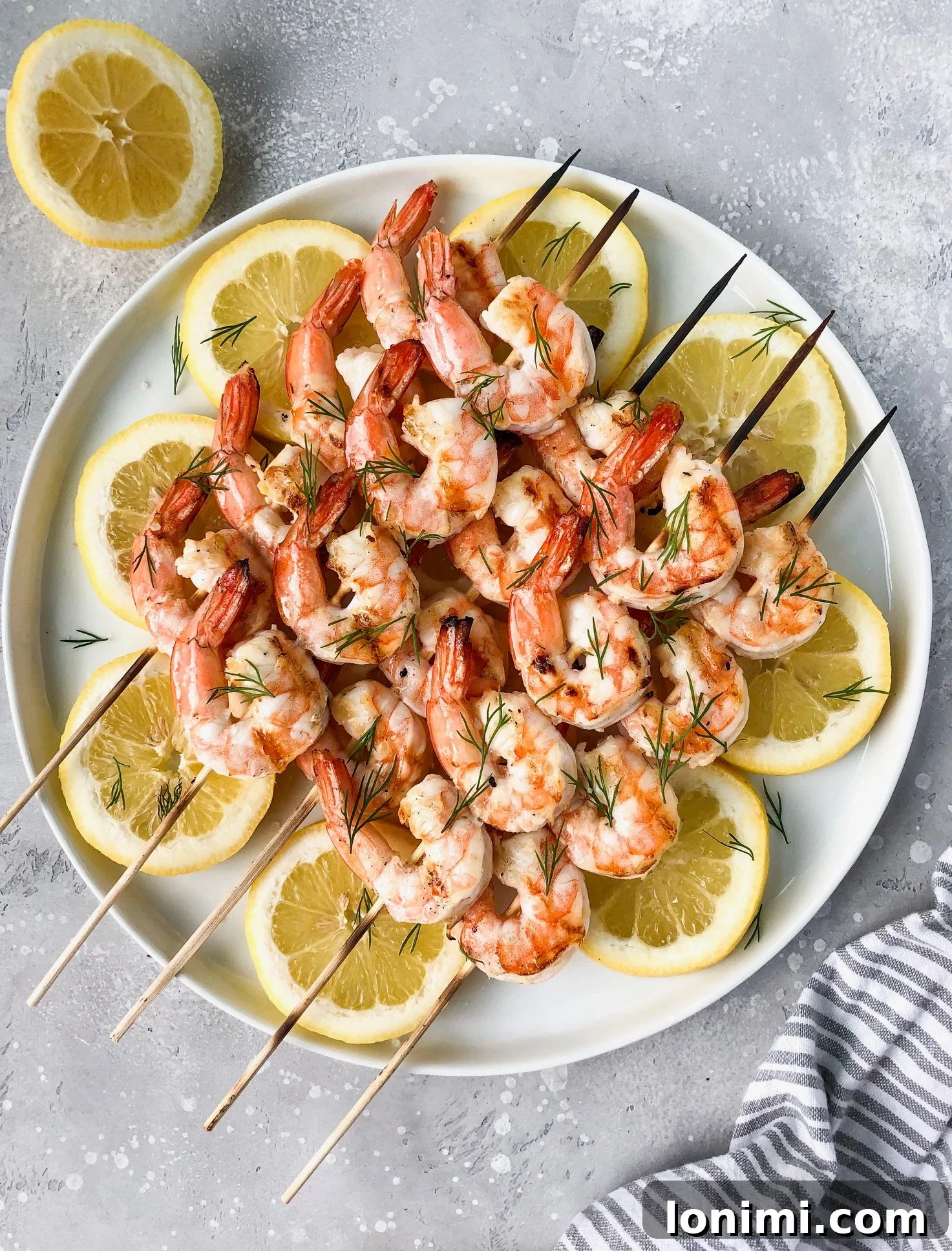 Juicy Grilled Garlic Butter Dill Shrimp served on a platter with lemon wedges