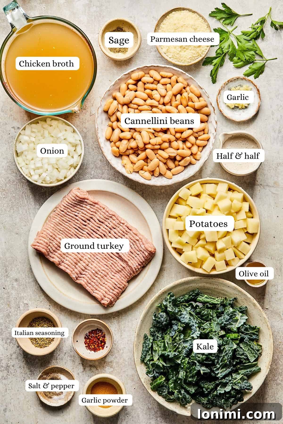 Fresh ingredients for Sausage Kale and White Bean Soup laid out on a kitchen counter, including ground turkey, fresh kale, canned cannellini beans, potatoes, onions, garlic, and spices.