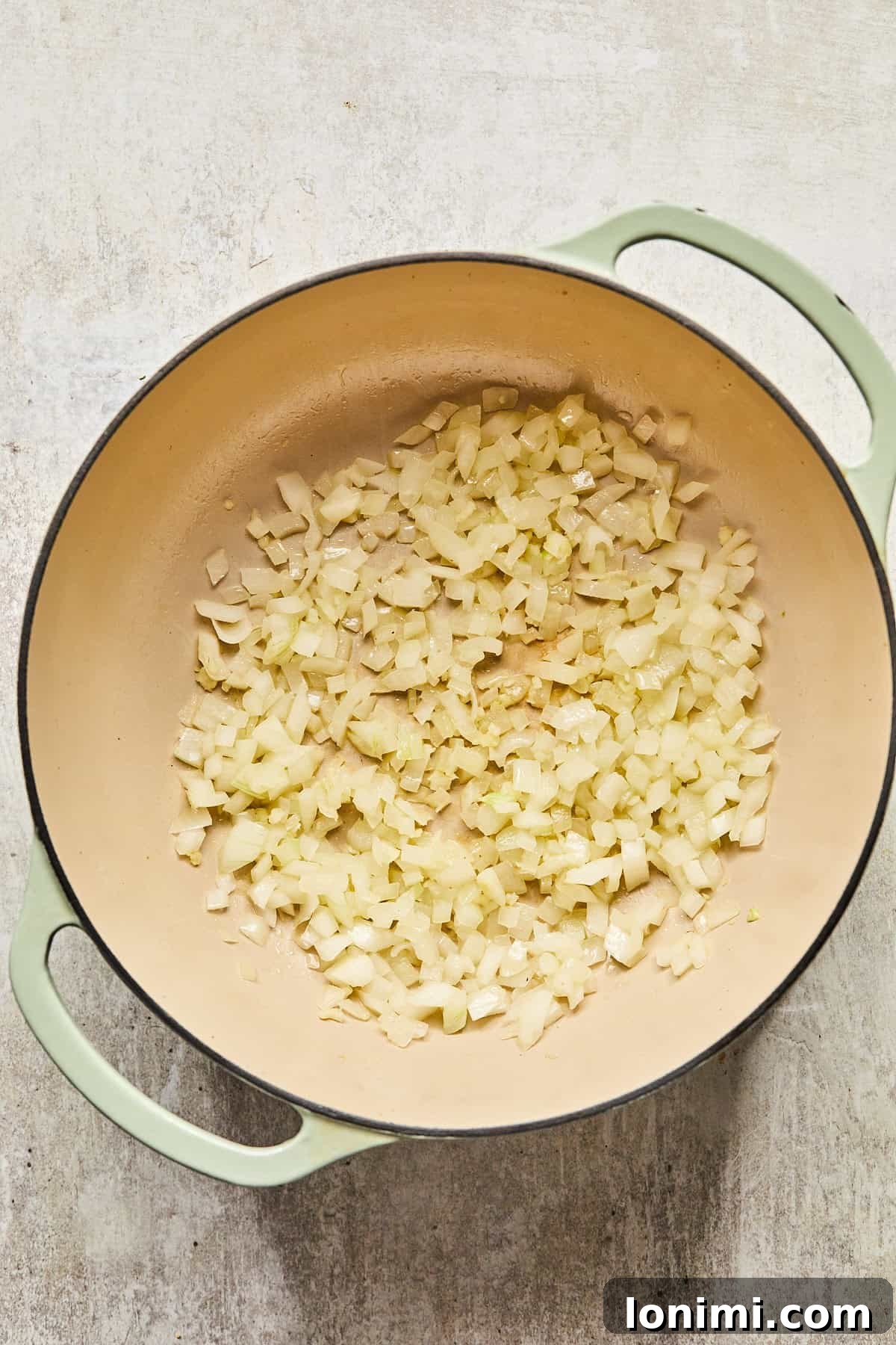 Sautéed diced onions and minced garlic in a pot, fragrant and translucent.