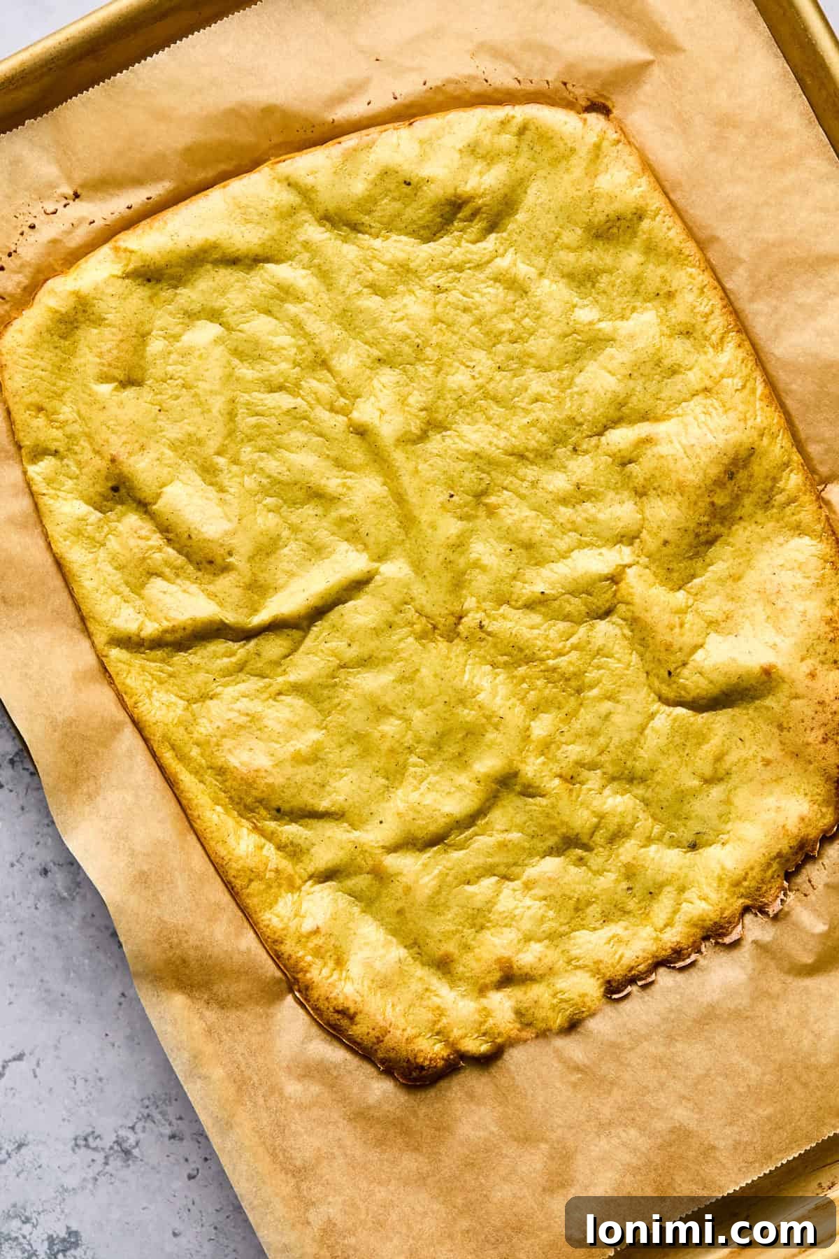baked cottage cheese flatbread on a baking sheet