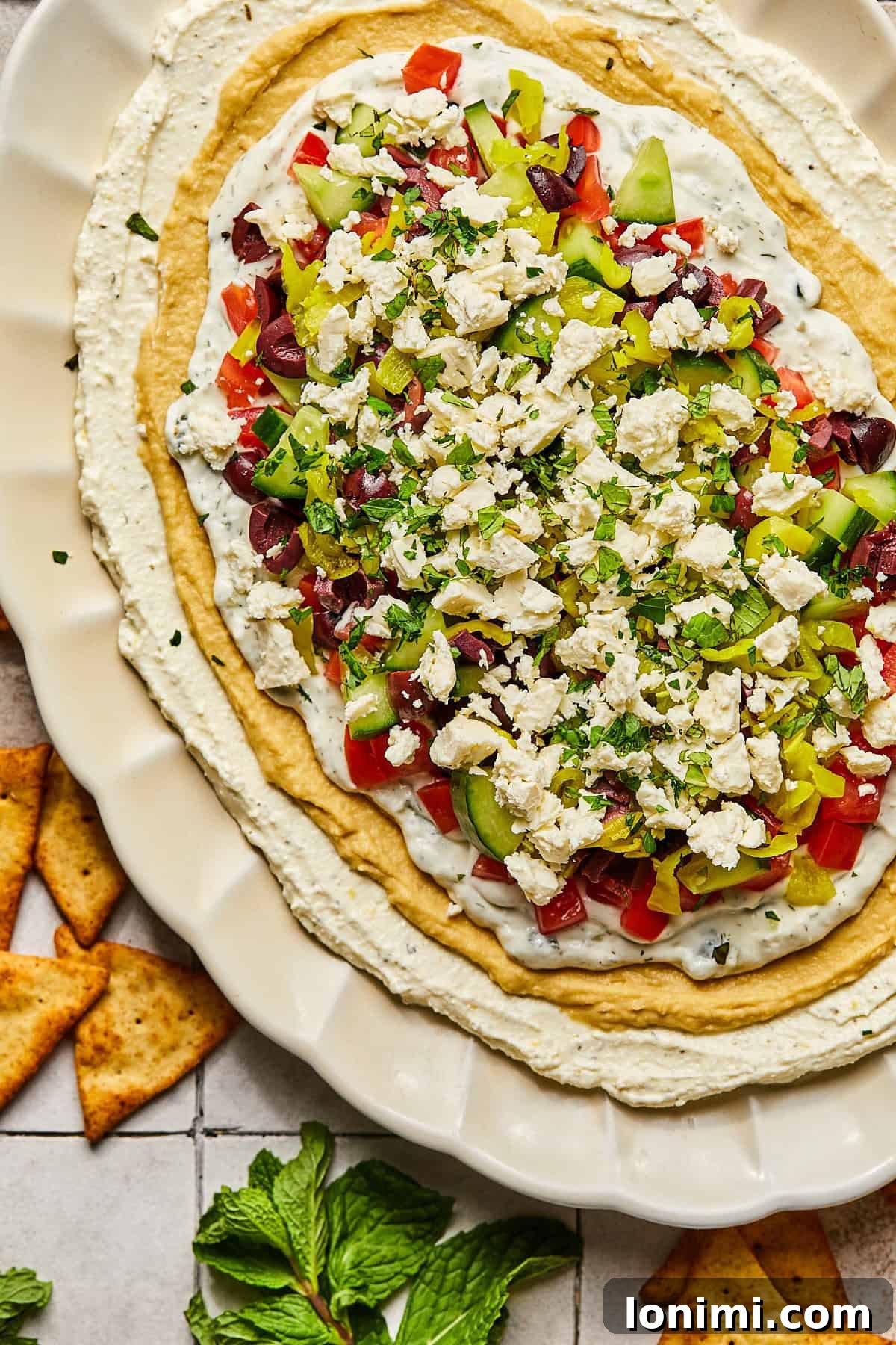 Effortless Mediterranean Layered Feta Dip 10 Greek dip surrounded by pita chips
