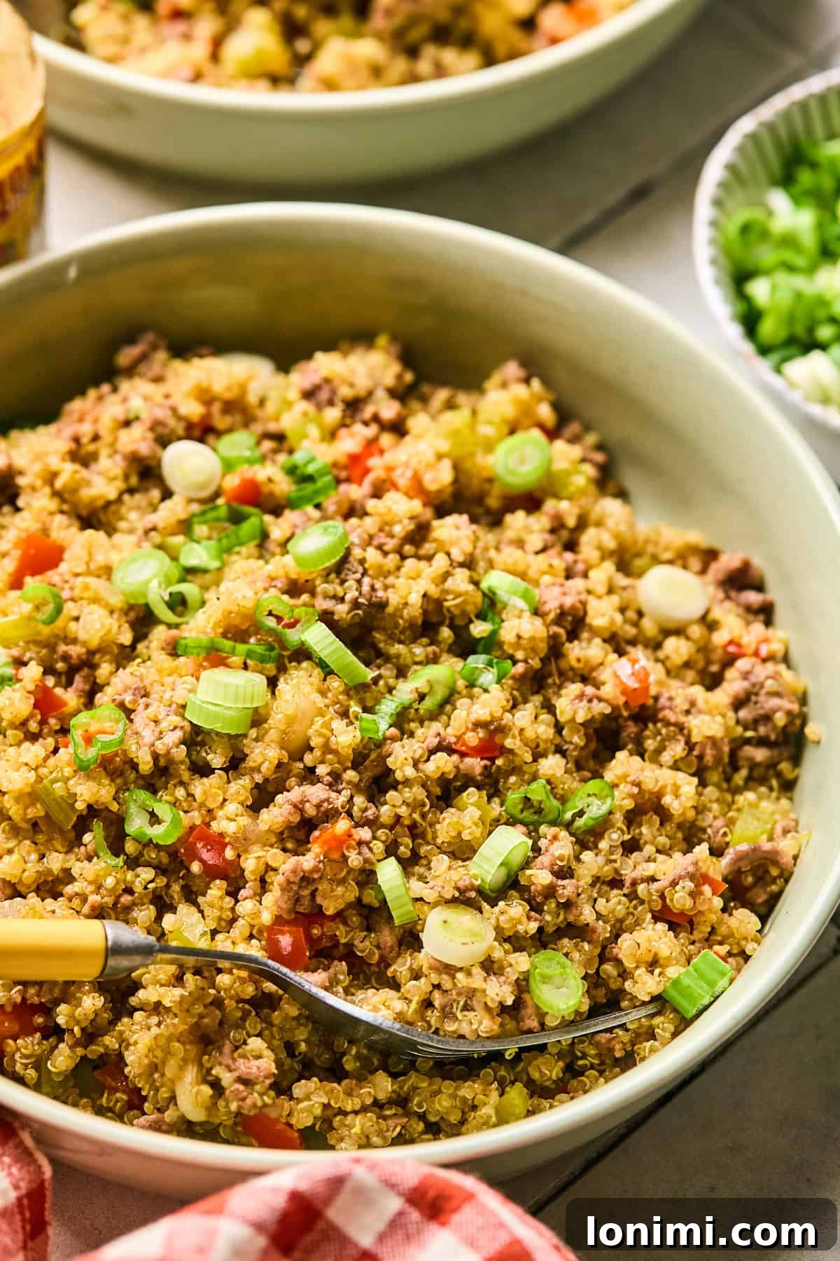 A vibrant bowl of Dirty Quinoa, presented with a fork, ready to be enjoyed.