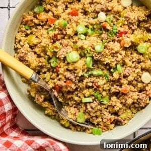 Dirty Quinoa in a bowl with a red and white checkered napkin next to it.