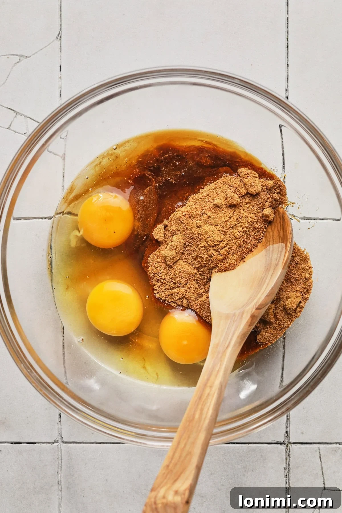 Rich Fudgy Protein Brownies With 7g Protein And A Clean Taste 5 Mixing eggs, coconut sugar, and vanilla into a glass bowl.