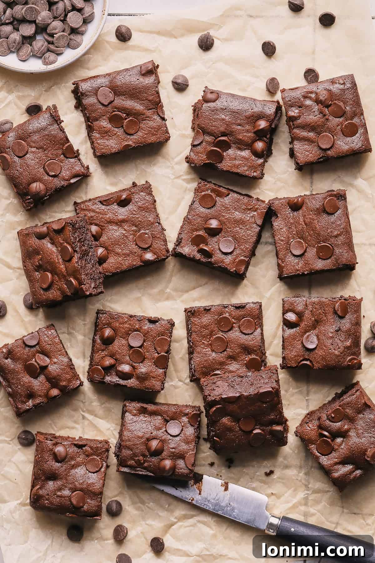 Rich Fudgy Protein Brownies With 7g Protein And A Clean Taste 9 Freshly baked fudgy protein brownies cooled and cut on parchment paper.