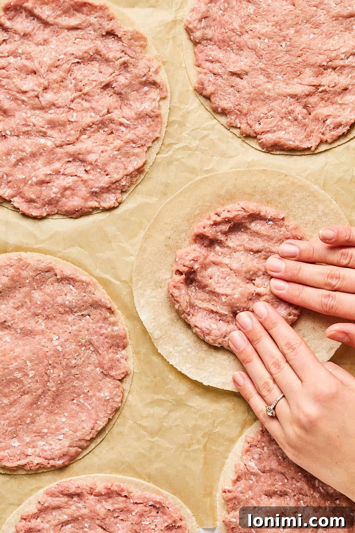 ground turkey being spread thin on tortillas